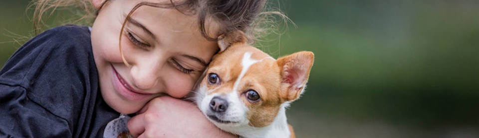 Kid holding dog